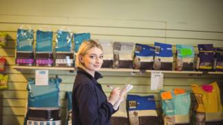 woman-writing-notepad-shop