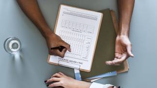 aerial-view-doctor-writing-patient-daily-report-checklist